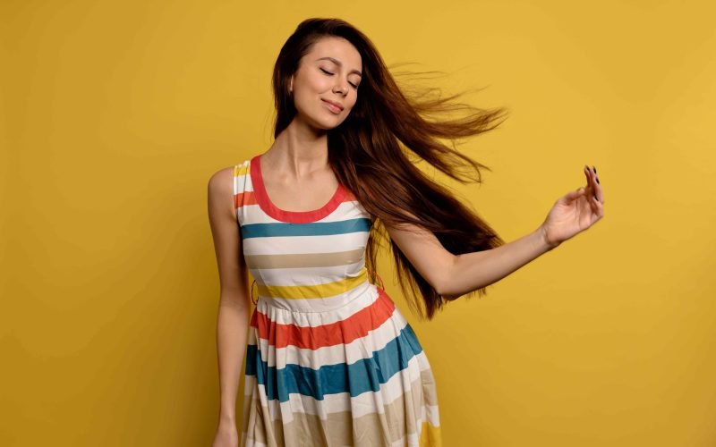 Woman enjoying frizz-free, silky smooth hair thanks to proper hair care