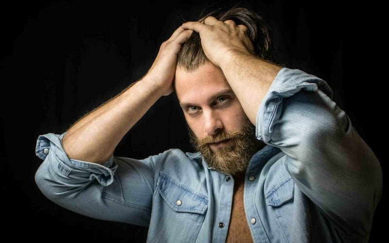 A man demonstrating proper face care with a beard for optimal skin health.