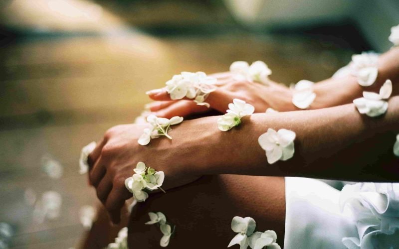 Priority of Skin Care - Hands adorned with flowers symbolizing healthy, well-cared-for skin.